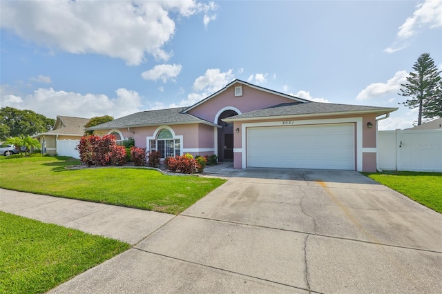2021 Elk Spring Dr, Brandon, FL 33511 - single story home with stucco siding, driveway, and an attached garage