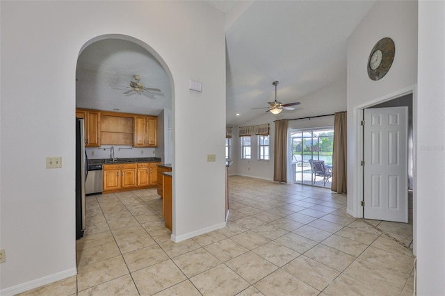 2021 Elk Spring Dr, Brandon, FL 33511 - kitchen with a ceiling fan, vaulted ceiling, open shelves, light tile patterned floors, and dark countertops