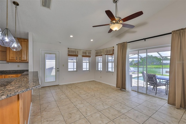 2021 Elk Spring Dr, Brandon, FL 33511 - unfurnished dining area with a ceiling fan, light tile patterned floors, vaulted ceiling, recessed lighting, and a water view