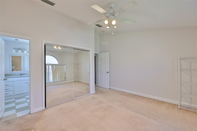 2021 Elk Spring Dr, Brandon, FL 33511 - unfurnished bedroom with light colored carpet, a closet, baseboards, and connected bathroom