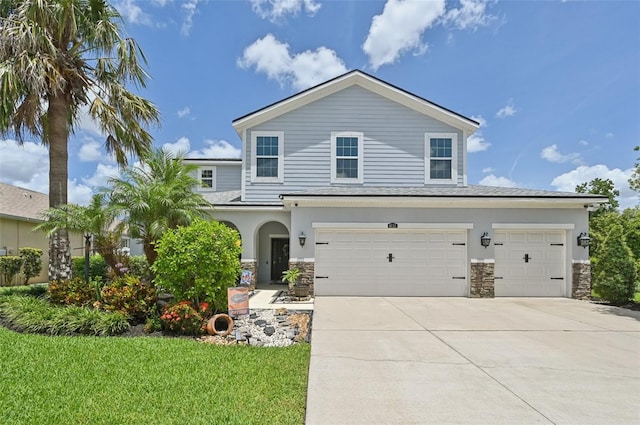 4151 Little Gap Loop, Ellenton, FL 34222 - view of front of home featuring driveway, stone siding, a garage, and stucco siding