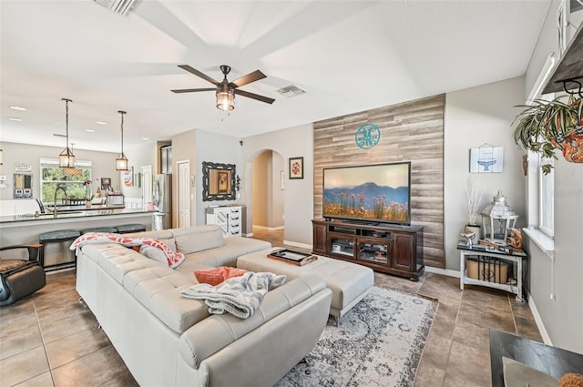 4151 Little Gap Loop, Ellenton, FL 34222 - living room with arched walkways, ceiling fan, and an accent wall
