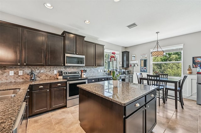 4151 Little Gap Loop, Ellenton, FL 34222 - kitchen featuring appliances with stainless steel finishes, decorative backsplash, plenty of natural light, dark brown cabinetry, and recessed lighting