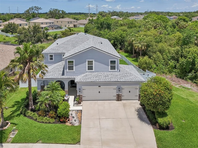 4151 Little Gap Loop, Ellenton, FL 34222 - view of front facade with concrete driveway, a garage, a front yard, and a shingled roof