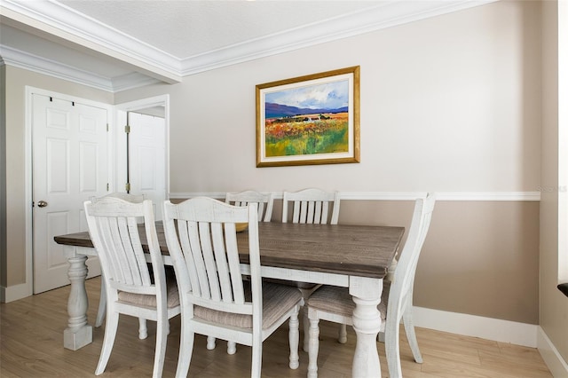 346 Gray Oak Dr, Tarpon Springs, FL 34689 - dining area with crown molding, light wood-type flooring, and baseboards