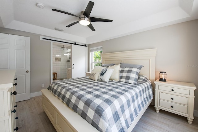 346 Gray Oak Dr, Tarpon Springs, FL 34689 - bedroom featuring light wood finished floors, a tray ceiling, and a ceiling fan