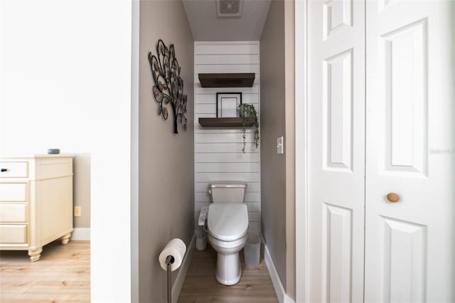 346 Gray Oak Dr, Tarpon Springs, FL 34689 - bathroom featuring wood finished floors, toilet, and baseboards