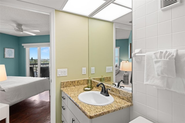 4510 Gulf Blvd Unit 604, St Pete Beach, FL 33706 - ensuite bathroom with vanity, ceiling fan, and wood finished floors