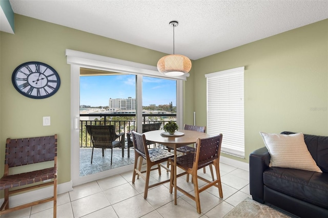4510 Gulf Blvd Unit 604, St Pete Beach, FL 33706 - dining room featuring light tile patterned floors, a textured ceiling, and a view of city