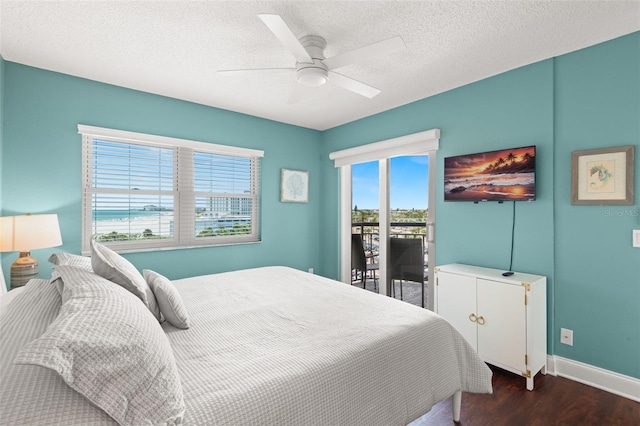 4510 Gulf Blvd Unit 604, St Pete Beach, FL 33706 - bedroom featuring dark wood-style floors, a textured ceiling, a ceiling fan, and access to outside