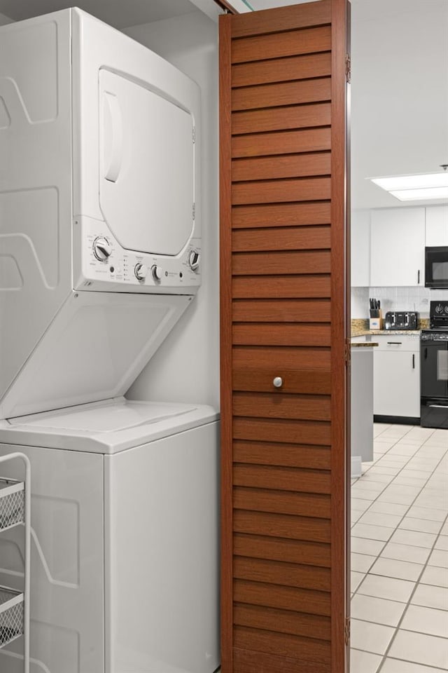 4510 Gulf Blvd Unit 604, St Pete Beach, FL 33706 - laundry room with stacked washer / drying machine and light tile patterned flooring
