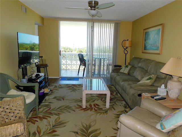 9 Forbes Pl Unit 310, Dunedin, FL 34698 - living area featuring ceiling fan, wood finished floors, and a textured ceiling