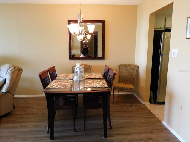 9 Forbes Pl Unit 310, Dunedin, FL 34698 - dining area featuring a chandelier and wood finished floors