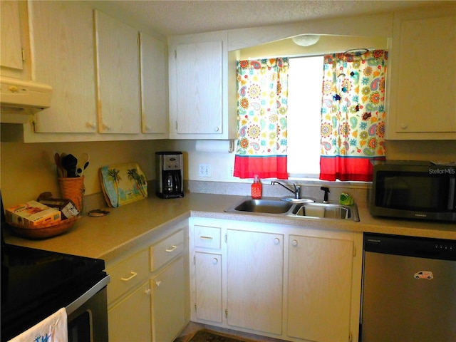 9 Forbes Pl Unit 310, Dunedin, FL 34698 - kitchen featuring appliances with stainless steel finishes, light countertops, and exhaust hood