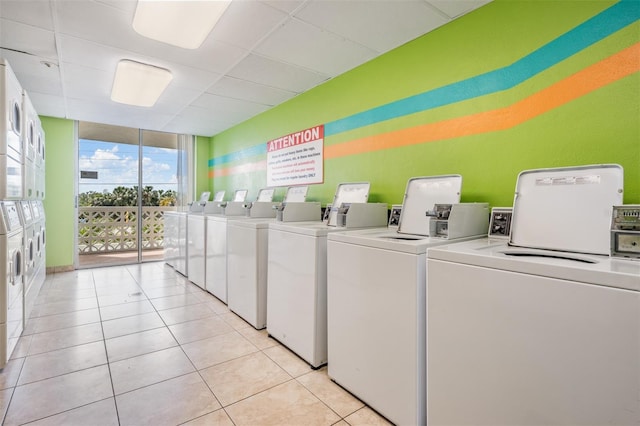 9 Forbes Pl Unit 310, Dunedin, FL 34698 - community laundry room with washer and clothes dryer and light tile patterned floors