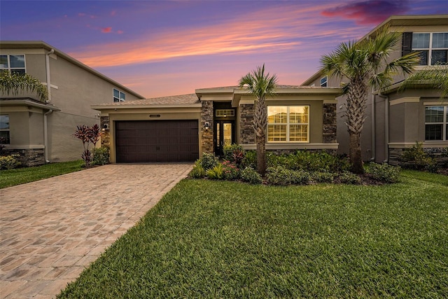 3318 Woodland Brook Way, Wesley Chapel, FL 33543 - view of front of property featuring stone siding, decorative driveway, a front lawn, and a garage