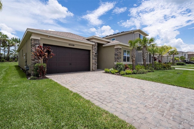 3318 Woodland Brook Way, Wesley Chapel, FL 33543 - view of front of house with stone siding, stucco siding, a garage, and decorative driveway