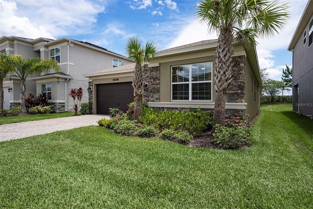 3318 Woodland Brook Way, Wesley Chapel, FL 33543 - view of front facade featuring stone siding, decorative driveway, an attached garage, and stucco siding