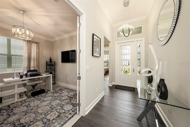 3318 Woodland Brook Way, Wesley Chapel, FL 33543 - foyer featuring a chandelier, plenty of natural light, ornamental molding, and dark wood-style floors