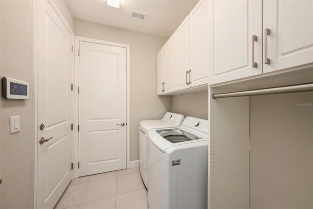 3318 Woodland Brook Way, Wesley Chapel, FL 33543 - washroom featuring washing machine and dryer, cabinet space, and light tile patterned flooring