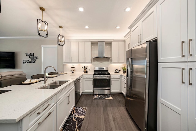 3318 Woodland Brook Way, Wesley Chapel, FL 33543 - kitchen featuring appliances with stainless steel finishes, wall chimney exhaust hood, a peninsula, white cabinets, and recessed lighting