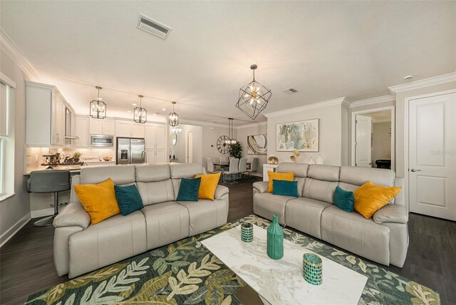 3318 Woodland Brook Way, Wesley Chapel, FL 33543 - living area with a chandelier, dark wood-type flooring, and crown molding