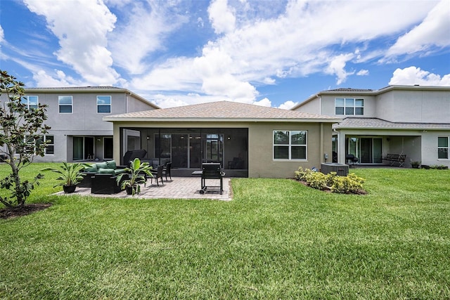 3318 Woodland Brook Way, Wesley Chapel, FL 33543 - rear view of house with a patio, stucco siding, a yard, outdoor lounge area, and a sunroom
