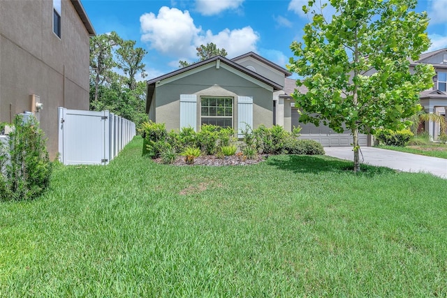 12907 Wildflower Meadow Dr, Riverview, FL 33579 - view of front of house with driveway, an attached garage, and stucco siding