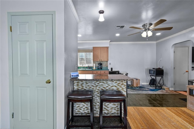 2501 18th Ave S, Saint Petersburg, FL 33712 - kitchen with a sink, ceiling fan, arched walkways, dark countertops, and a peninsula