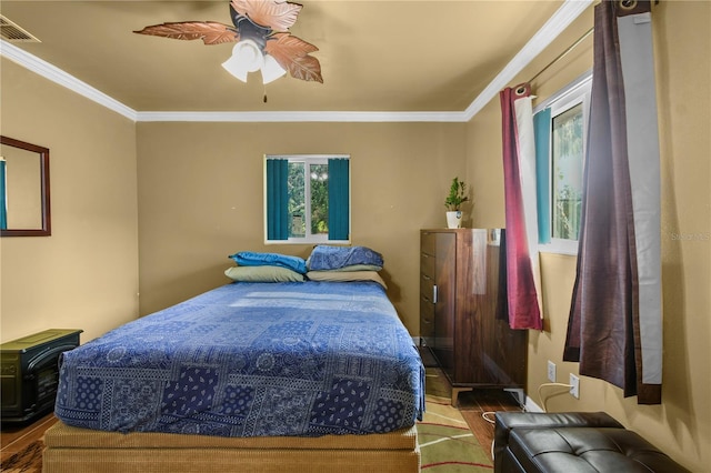 2501 18th Ave S, Saint Petersburg, FL 33712 - bedroom featuring wood finished floors, crown molding, multiple windows, and ceiling fan