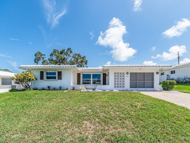 14045 90th Pl, Seminole, FL 33776 - ranch-style house featuring stucco siding, driveway, a front yard, and a garage