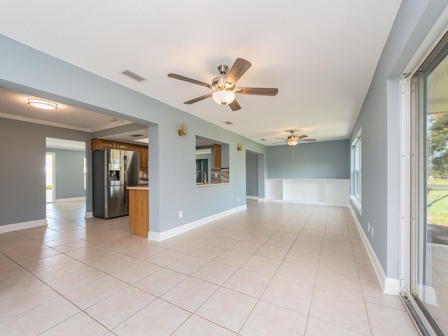 14045 90th Pl, Seminole, FL 33776 - spare room with light tile patterned floors, ceiling fan, and baseboards