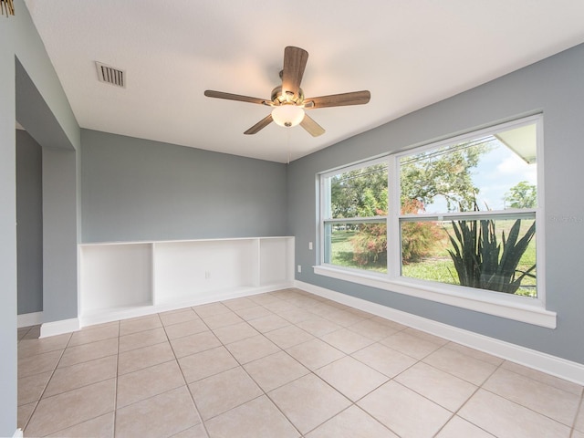 14045 90th Pl, Seminole, FL 33776 - empty room featuring ceiling fan, baseboards, and light tile patterned floors