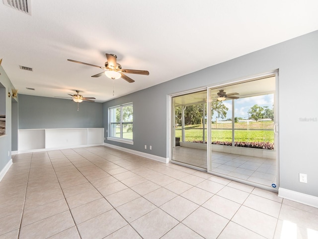 14045 90th Pl, Seminole, FL 33776 - spare room featuring ceiling fan, light tile patterned floors, and baseboards