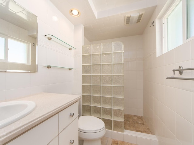 14045 90th Pl, Seminole, FL 33776 - full bath with tile walls, a walk in shower, vanity, and toilet