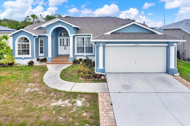 23917 Pow Wow Dr, Lutz, FL 33559 - single story home featuring a garage, stucco siding, driveway, and a front yard