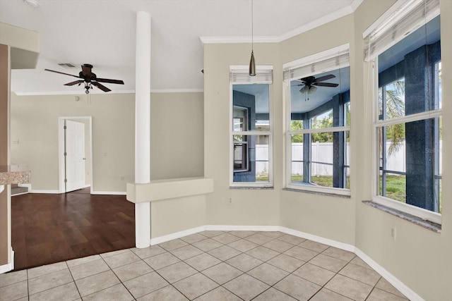 23917 Pow Wow Dr, Lutz, FL 33559 - unfurnished dining area with a ceiling fan, tile patterned floors, crown molding, and baseboards