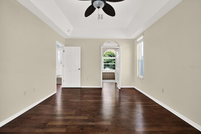23917 Pow Wow Dr, Lutz, FL 33559 - spare room featuring a raised ceiling, ceiling fan, dark wood-type flooring, and baseboards