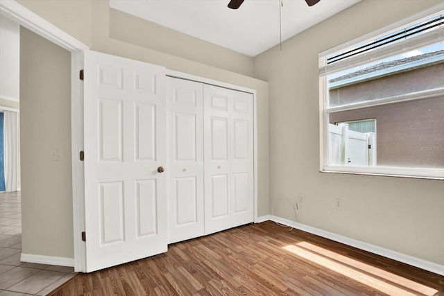23917 Pow Wow Dr, Lutz, FL 33559 - unfurnished bedroom featuring baseboards, wood finished floors, a closet, and a ceiling fan