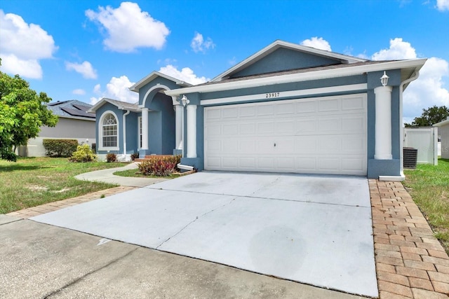 23917 Pow Wow Dr, Lutz, FL 33559 - ranch-style home featuring stucco siding, driveway, an attached garage, and a front lawn