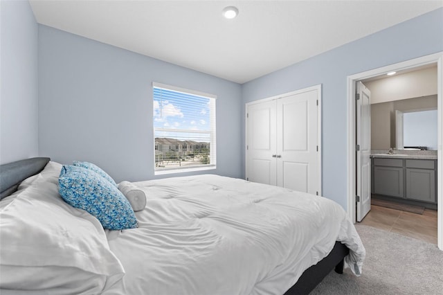 308 Mangrove Shade Cir, Apollo Beach, FL 33572 - bedroom featuring a closet, ensuite bath, and light tile patterned floors