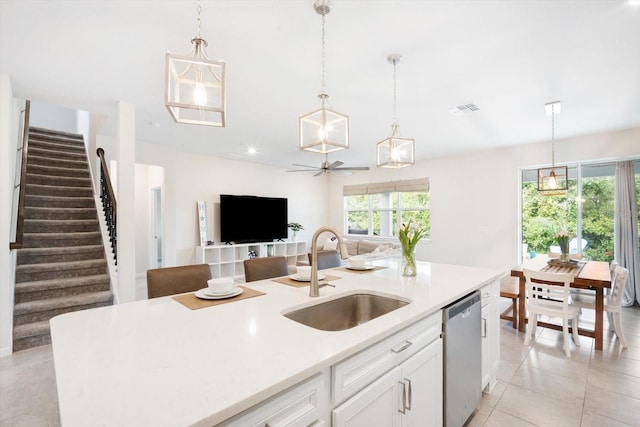13157 Peachleaf Ave, Riverview, FL 33579 - kitchen featuring a sink, stainless steel dishwasher, light countertops, and decorative light fixtures