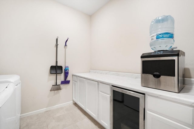 13157 Peachleaf Ave, Riverview, FL 33579 - laundry room featuring beverage cooler, washing machine and dryer, cabinet space, and baseboards