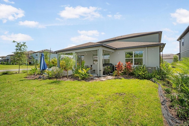 13157 Peachleaf Ave, Riverview, FL 33579 - rear view of house with a lawn and stucco siding