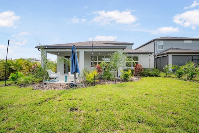 13157 Peachleaf Ave, Riverview, FL 33579 - rear view of house featuring a yard, a patio, stucco siding, and a sunroom