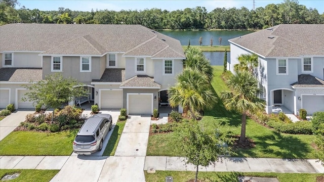 7916 Evergreen Creek Ct, Riverview, FL 33578 - multi unit property with driveway, a water view, stucco siding, a garage, and a shingled roof