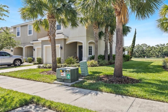 7916 Evergreen Creek Ct, Riverview, FL 33578 - view of front of house with an attached garage, concrete driveway, stucco siding, and a front yard