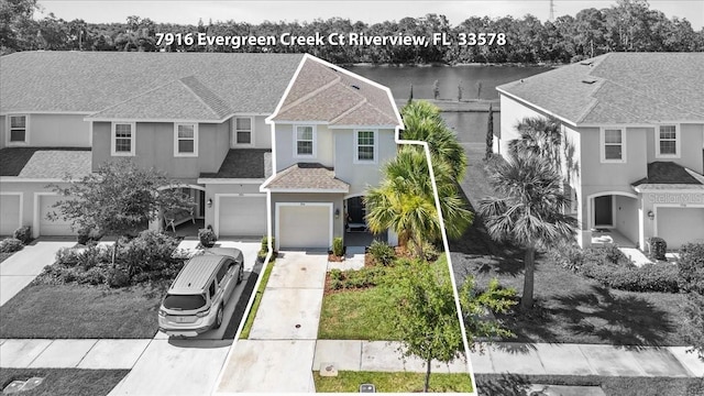7916 Evergreen Creek Ct, Riverview, FL 33578 - view of front of property with concrete driveway, a garage, stucco siding, and roof with shingles
