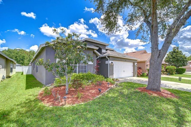 31349 Philmar Ln, Wesley Chapel, FL 33543 - view of front of home featuring stucco siding, an attached garage, and driveway