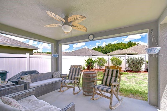31349 Philmar Ln, Wesley Chapel, FL 33543 - fenced backyard with an outdoor living space, ceiling fan, and a patio